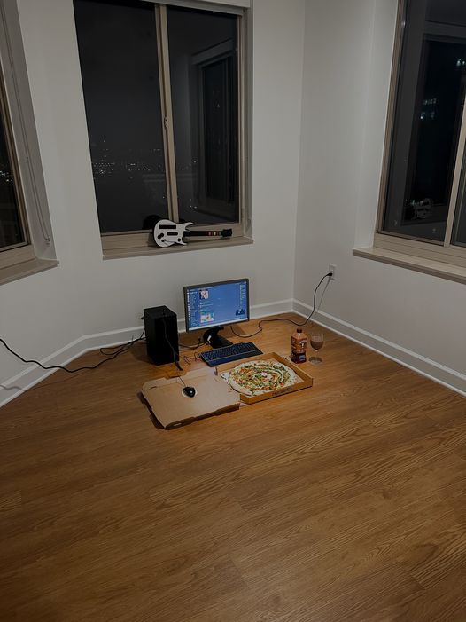 This meme depicts a dark and empty room with a computer setup, including a monitor, keyboard, and mouse. The text "I'm not lazy, I'm just on energy-saving mode" is displayed on the screen, implying that the person is not actually working, but rather conserving energy.